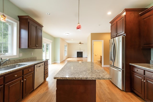 1705 Orchard Rd, Berlin, CT 06037 - kitchen with appliances with stainless steel finishes, a kitchen island, light wood-style floors, open floor plan, and hanging light fixtures