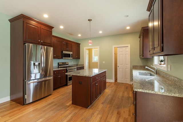 1705 Orchard Rd, Berlin, CT 06037 - kitchen featuring appliances with stainless steel finishes, a kitchen island, light wood-style floors, light stone countertops, and recessed lighting