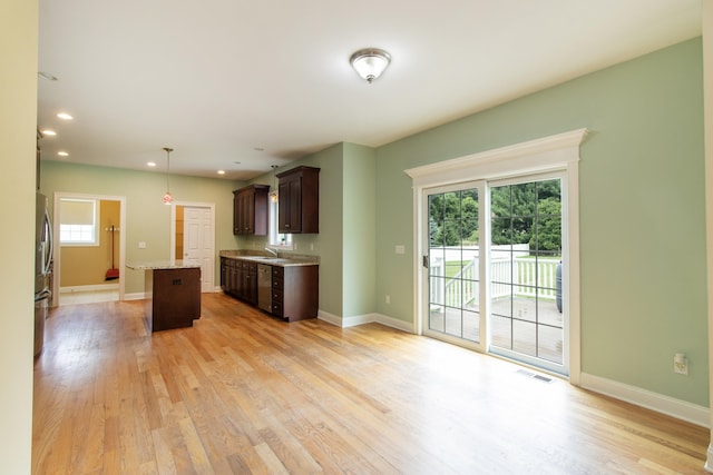 1705 Orchard Rd, Berlin, CT 06037 - kitchen featuring dark brown cabinets, stainless steel appliances, light wood-style floors, a kitchen island, and decorative light fixtures