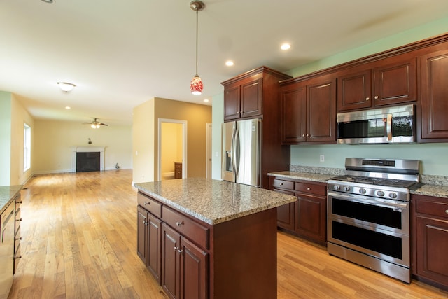 1705 Orchard Rd, Berlin, CT 06037 - kitchen with appliances with stainless steel finishes, a kitchen island, open floor plan, ceiling fan, and light wood-type flooring