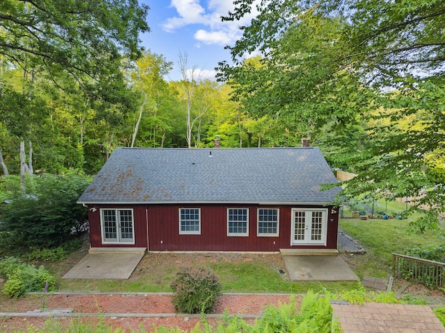 9 Philip Ln, Ledyard, CT 06339 - rear view of property featuring french doors, a shingled roof, and a patio