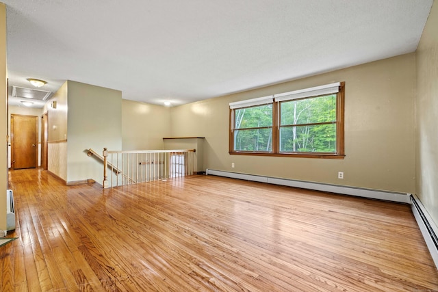 9 Philip Ln, Ledyard, CT 06339 - unfurnished room featuring a baseboard heating unit and wood-type flooring