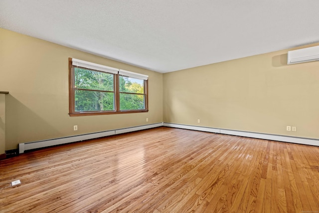 9 Philip Ln, Ledyard, CT 06339 - spare room featuring wood finished floors, a wall unit AC, and baseboard heating