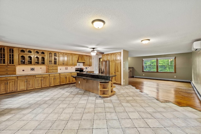 9 Philip Ln, Ledyard, CT 06339 - kitchen with baseboard heating, stainless steel refrigerator, ceiling fan, glass insert cabinets, and a textured ceiling
