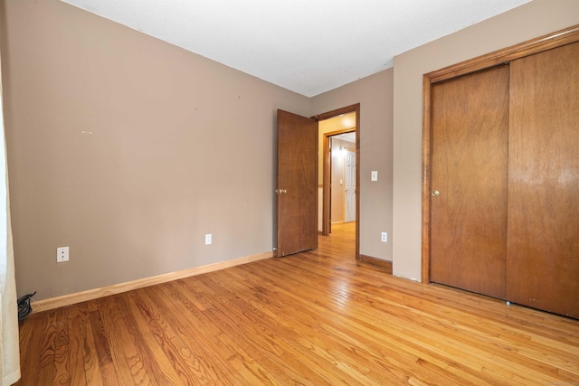 9 Philip Ln, Ledyard, CT 06339 - unfurnished bedroom with light wood-style floors and a closet