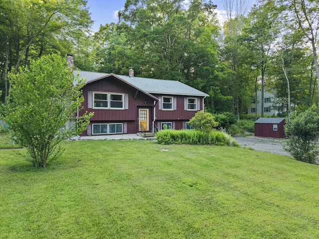 9 Philip Ln, Ledyard, CT 06339 - split foyer home featuring a chimney, a front lawn, and an outdoor structure