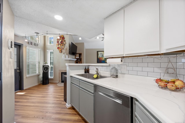 136 Carriage Crossing Ln Unit 136, Middletown, CT 06457 - kitchen with dishwasher, tasteful backsplash, light wood-style flooring, white cabinets, and a textured ceiling