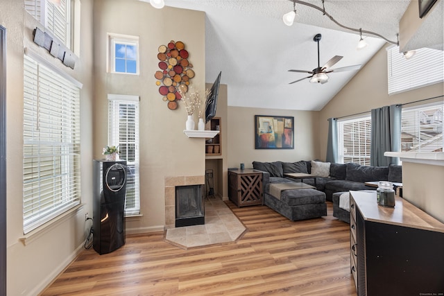 136 Carriage Crossing Ln Unit 136, Middletown, CT 06457 - living room featuring high vaulted ceiling, ceiling fan, light wood finished floors, and a tiled fireplace