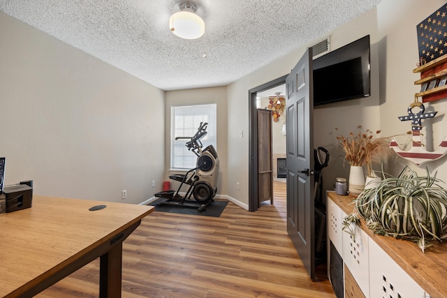 136 Carriage Crossing Ln Unit 136, Middletown, CT 06457 - exercise area with a textured ceiling and light wood-style floors