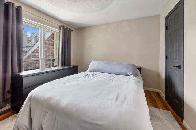 136 Carriage Crossing Ln Unit 136, Middletown, CT 06457 - bedroom with wood finished floors and a textured ceiling