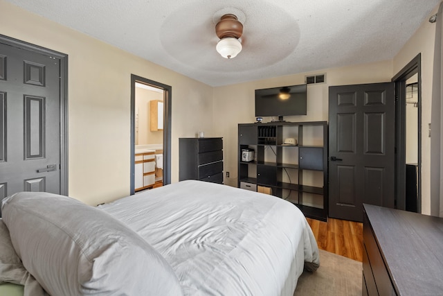 136 Carriage Crossing Ln Unit 136, Middletown, CT 06457 - bedroom with wood finished floors, a ceiling fan, and a textured ceiling