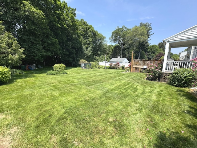 155 Harding St, New Britain, CT 06052 - view of grassy yard with a deck and view of scattered trees