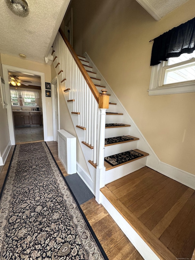 155 Harding St, New Britain, CT 06052 - staircase with a textured ceiling, ceiling fan, and wood finished floors