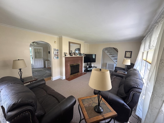155 Harding St, New Britain, CT 06052 - carpeted living room featuring arched walkways, a brick fireplace, ornamental molding, and stairway