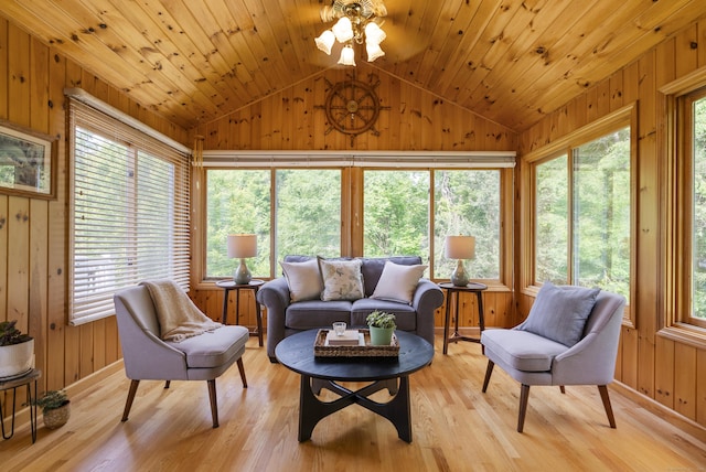 109 Andrew Dr, Canton, CT 06019 - living area with wooden walls, vaulted ceiling, light wood finished floors, plenty of natural light, and ceiling fan