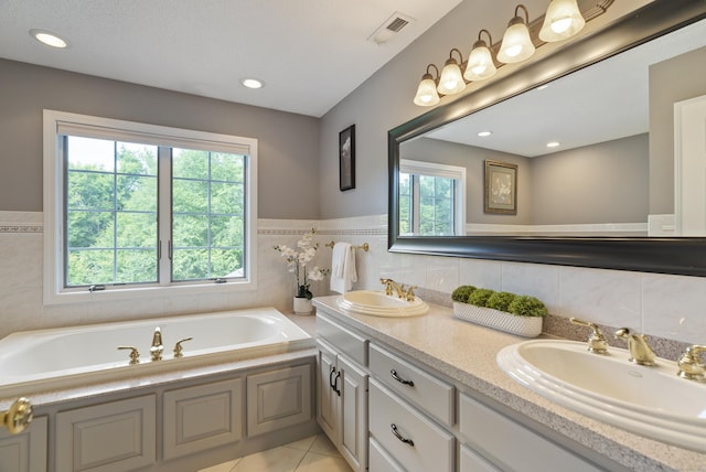 109 Andrew Dr, Canton, CT 06019 - bathroom with healthy amount of natural light, double vanity, a bath, tile walls, and tile patterned floors