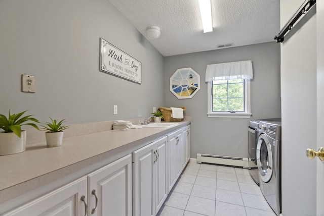 109 Andrew Dr, Canton, CT 06019 - washroom with baseboard heating, separate washer and dryer, cabinet space, a textured ceiling, and light tile patterned floors