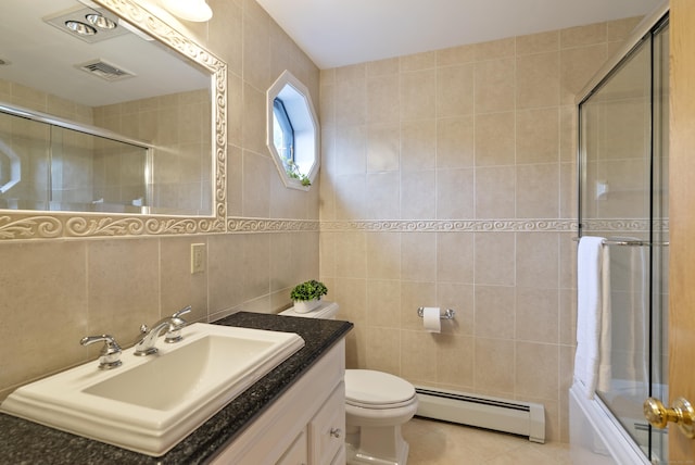 109 Andrew Dr, Canton, CT 06019 - full bath featuring baseboard heating, tile walls, vanity, tile patterned flooring, and combined bath / shower with glass door