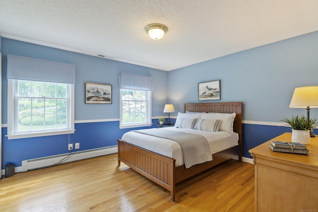 109 Andrew Dr, Canton, CT 06019 - bedroom with baseboard heating, wood finished floors, and a textured ceiling