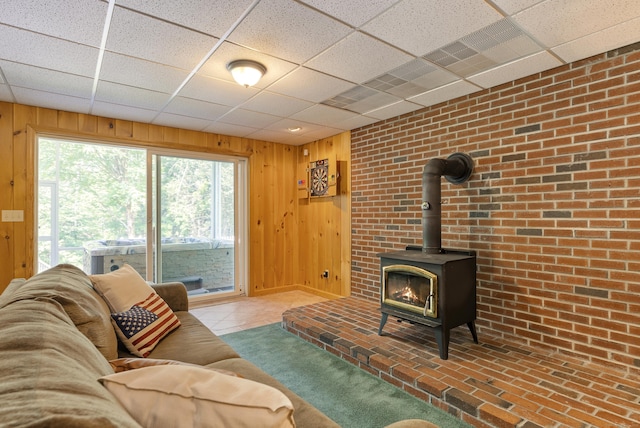 109 Andrew Dr, Canton, CT 06019 - living area featuring wooden walls, a wood stove, and a drop ceiling