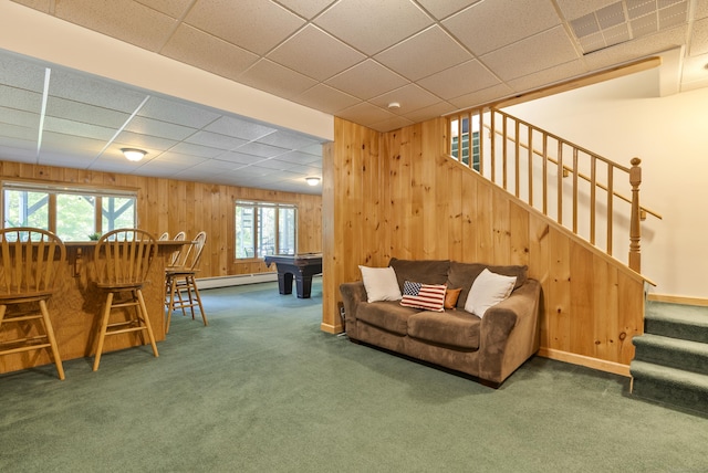 109 Andrew Dr, Canton, CT 06019 - carpeted living area with a baseboard heating unit, stairway, wooden walls, a paneled ceiling, and healthy amount of natural light