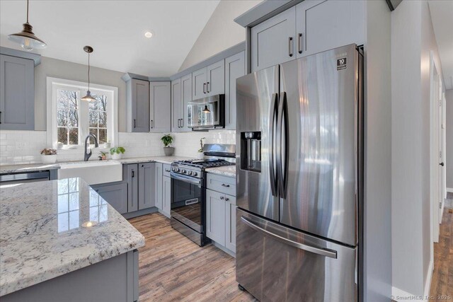 110 Willowbrook Rd, Cromwell, CT 06416 - kitchen featuring appliances with stainless steel finishes, gray cabinetry, a sink, lofted ceiling, and backsplash