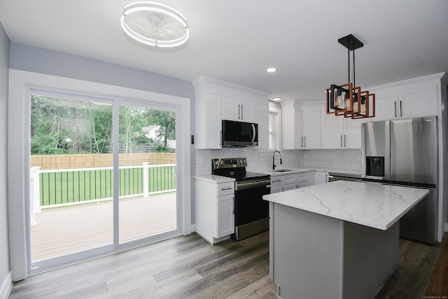 10 Yale Dr, Enfield, CT 06082 - kitchen with stainless steel appliances, decorative backsplash, a sink, white cabinetry, and dark wood-style flooring
