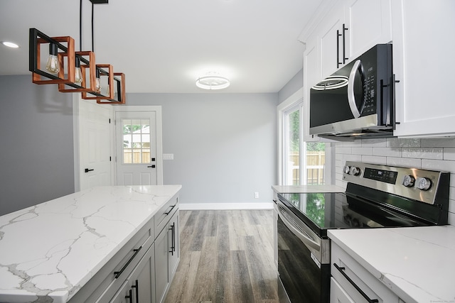 10 Yale Dr, Enfield, CT 06082 - kitchen with appliances with stainless steel finishes, light wood-type flooring, baseboards, pendant lighting, and light stone counters