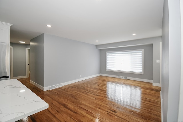 10 Yale Dr, Enfield, CT 06082 - unfurnished living room featuring wood finished floors, baseboards, and recessed lighting