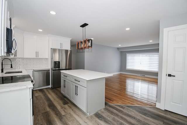 10 Yale Dr, Enfield, CT 06082 - kitchen with appliances with stainless steel finishes, a sink, decorative backsplash, a chandelier, and recessed lighting