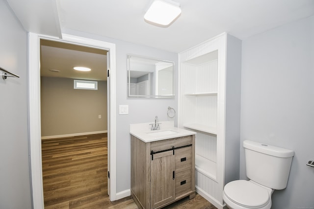 10 Yale Dr, Enfield, CT 06082 - bathroom with vanity, toilet, wood finished floors, and baseboards