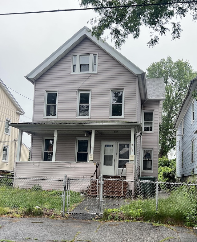 201 Lewis St, Bridgeport, CT 06605 - view of front facade featuring covered porch, a fenced front yard, and a gate