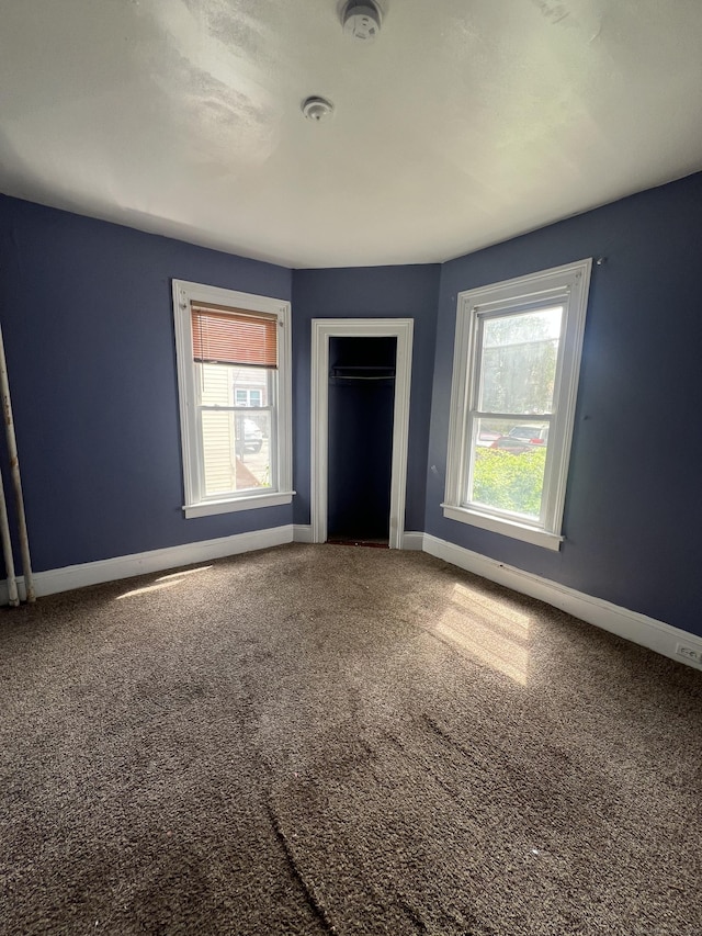 201 Lewis St, Bridgeport, CT 06605 - unfurnished bedroom featuring baseboards, carpet flooring, and a closet