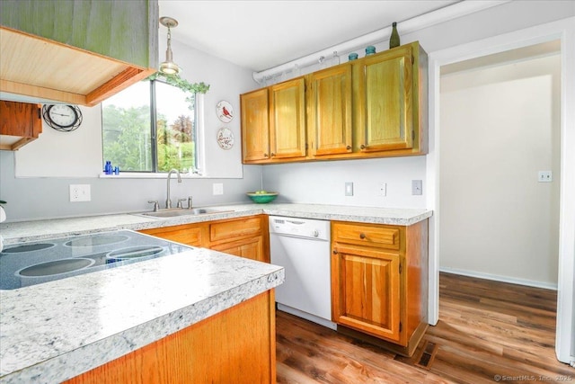 192 Heritage Vlg Unit A, Southbury, CT 06488 - kitchen featuring white dishwasher, light countertops, dark wood-type flooring, hanging light fixtures, and brown cabinetry