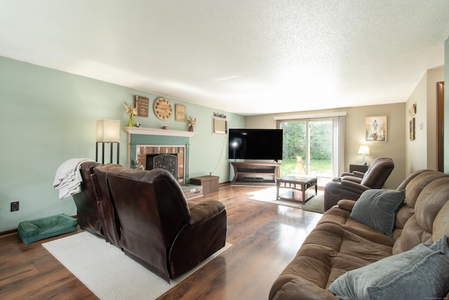 47 Pebble Dr, Newington, CT 06111 - living area featuring wood finished floors, a fireplace, and a textured ceiling