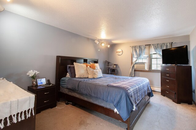 47 Pebble Dr, Newington, CT 06111 - bedroom featuring light carpet, a textured ceiling, a baseboard radiator, and rail lighting