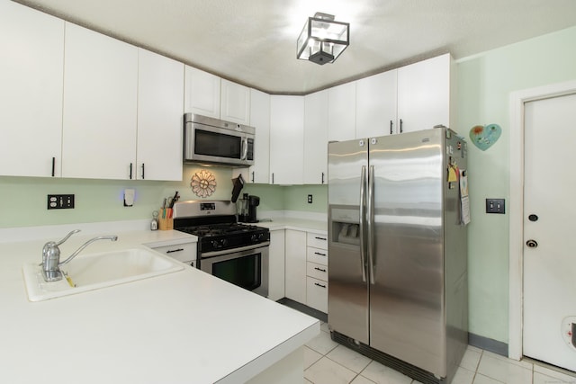 47 Pebble Dr, Newington, CT 06111 - kitchen featuring stainless steel appliances, light countertops, white cabinetry, and light tile patterned flooring