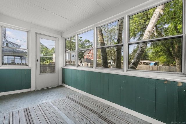 3 Price Ct, East Hartford, CT 06108 - unfurnished sunroom featuring baseboards, wood finished floors, a wooden deck, and wood walls