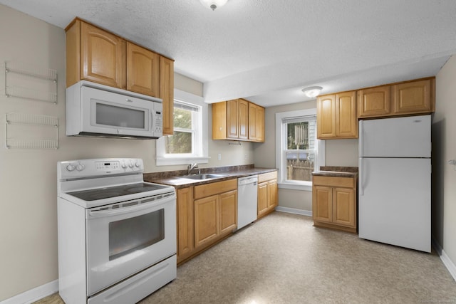 3 Price Ct, East Hartford, CT 06108 - kitchen featuring white appliances, a sink, dark countertops, baseboards, and a textured ceiling