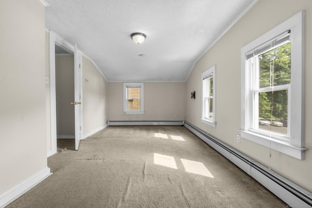 3 Price Ct, East Hartford, CT 06108 - empty room with a baseboard heating unit, a textured ceiling, carpet flooring, ornamental molding, and lofted ceiling