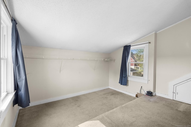 3 Price Ct, East Hartford, CT 06108 - bonus room with vaulted ceiling, carpet flooring, baseboards, and a textured ceiling