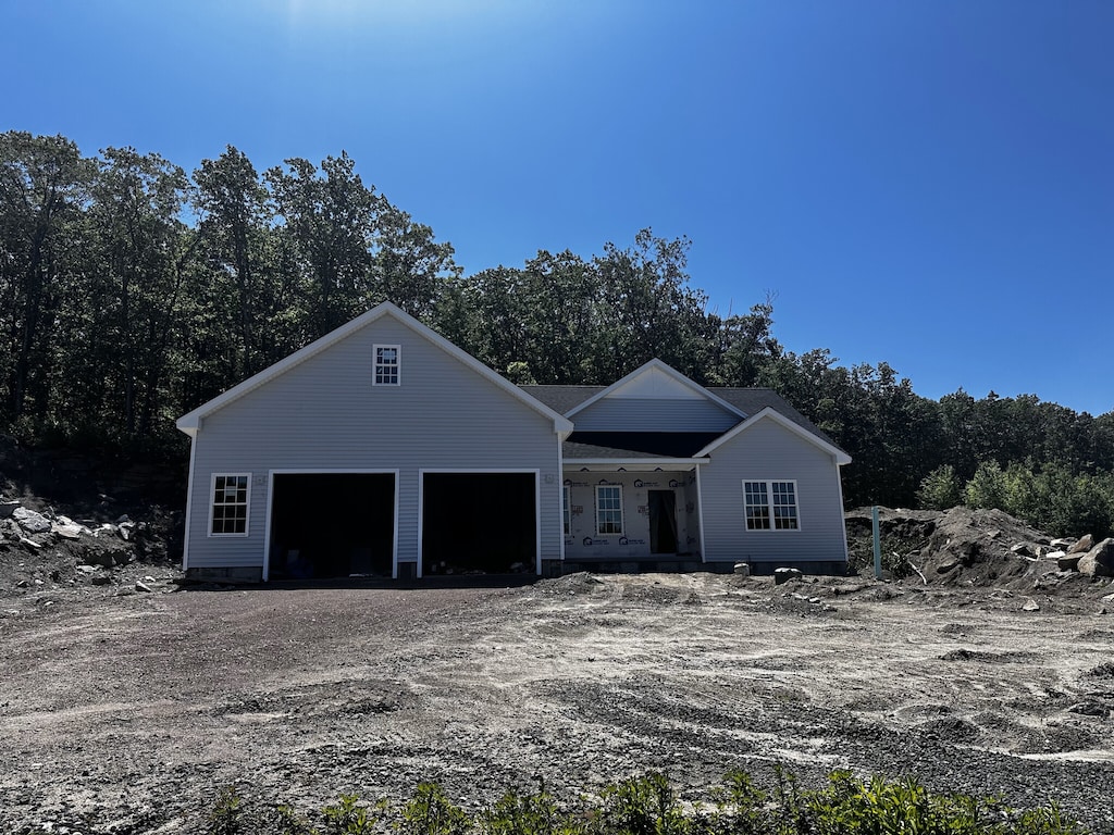 74 Rock Ridge Rd, Manchester, CT 06040 - view of front of house featuring an attached garage and dirt driveway