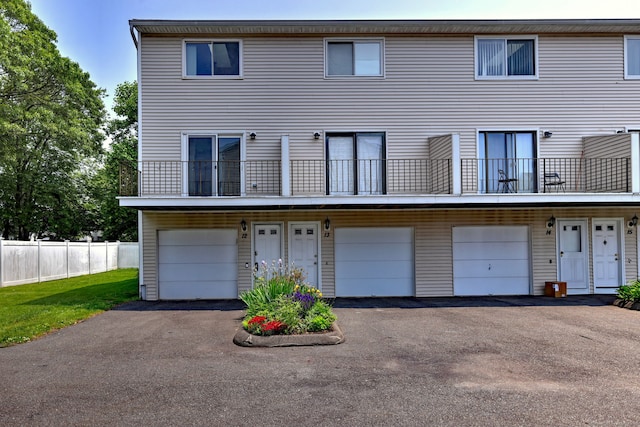 269 Captain Thomas Blvd Unit 12, West Haven, CT 06516 - rear view of property with a garage, driveway, and a balcony