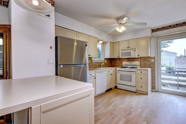 269 Captain Thomas Blvd Unit 12, West Haven, CT 06516 - kitchen with white appliances, cream cabinets, light countertops, ceiling fan, and a textured ceiling
