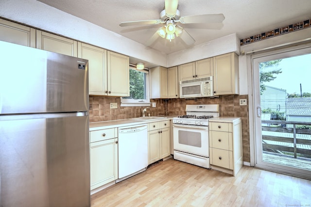 269 Captain Thomas Blvd Unit 12, West Haven, CT 06516 - kitchen featuring white appliances, cream cabinetry, light countertops, light wood finished floors, and a sink