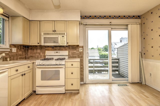269 Captain Thomas Blvd Unit 12, West Haven, CT 06516 - kitchen with white appliances, a sink, cream cabinets, light wood-style floors, and light countertops