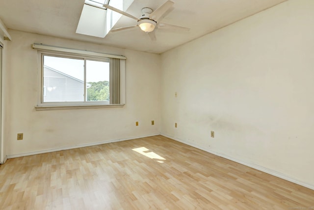 269 Captain Thomas Blvd Unit 12, West Haven, CT 06516 - empty room with wood finished floors, a ceiling fan, a skylight, and baseboards
