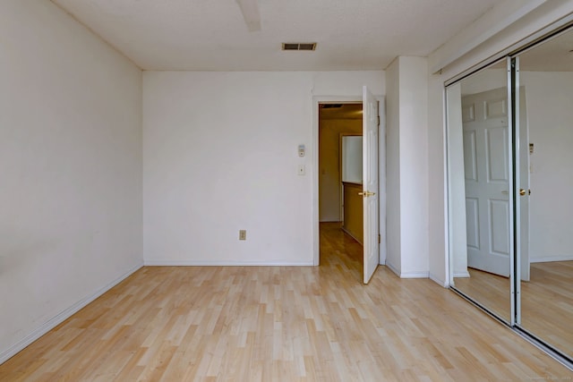 269 Captain Thomas Blvd Unit 12, West Haven, CT 06516 - unfurnished bedroom with light wood-style flooring, a closet, and baseboards
