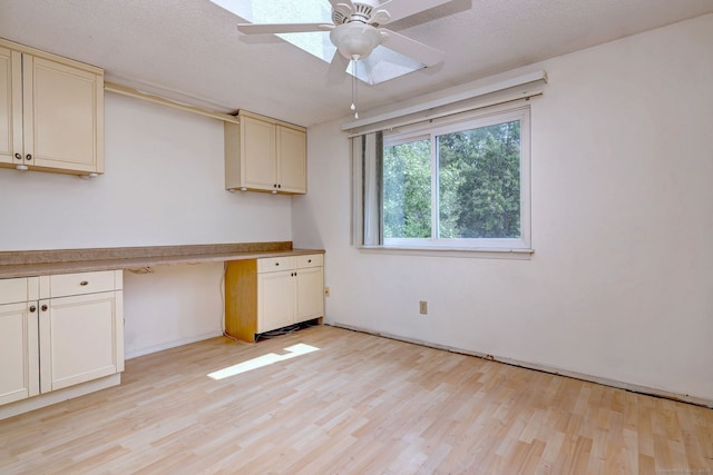 269 Captain Thomas Blvd Unit 12, West Haven, CT 06516 - kitchen featuring cream cabinetry, light wood-type flooring, a ceiling fan, and baseboards