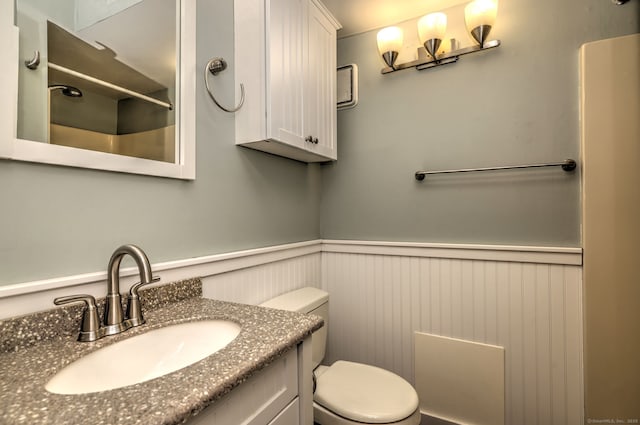 269 Captain Thomas Blvd Unit 12, West Haven, CT 06516 - full bathroom featuring toilet, a wainscoted wall, vanity, and a shower